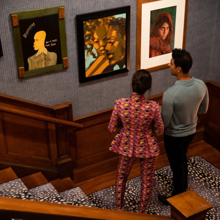 A photo of a couple looking at the art at The 'Quin House