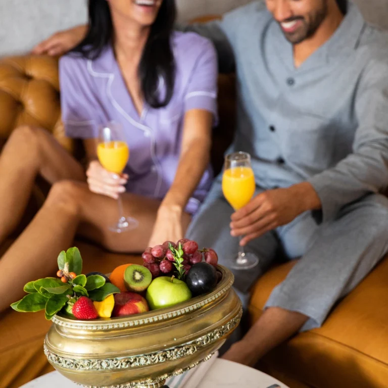 Image of a couple enjoying mimosas and fruit while staying at The 'Quin House